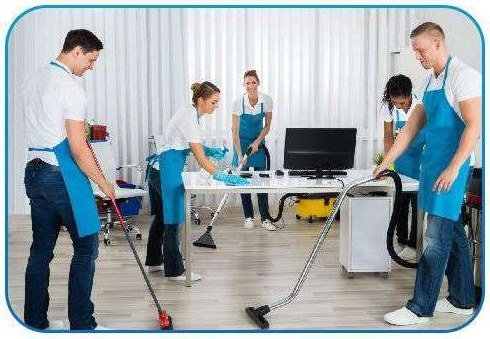 Office support staff cleaning a modern workspace